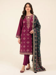 A woman modeling a traditional three-piece salwar kameez suit in deep magenta, featuring intricate gold embroidery on the kurta, matching trousers, and a dark green dupatta with gold and silver patterns.